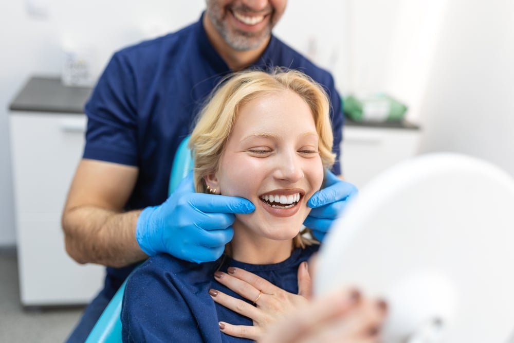 Happy woman getting a dental checkup from a dentist.